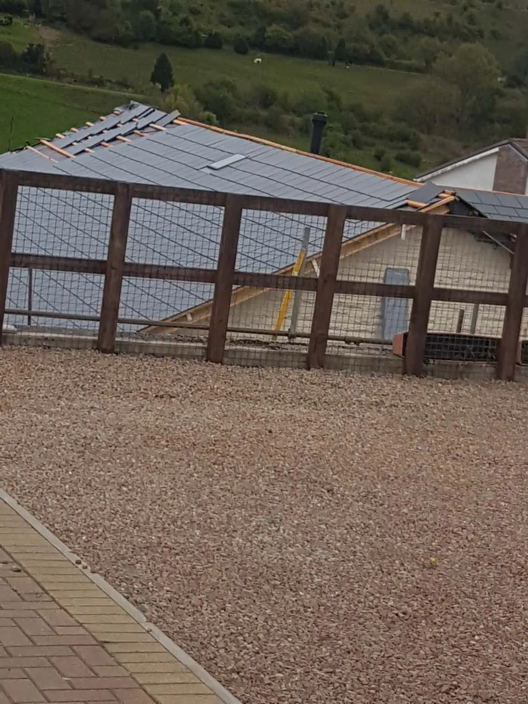Bungalow roof part way through re-slating with battens showing at the ridge