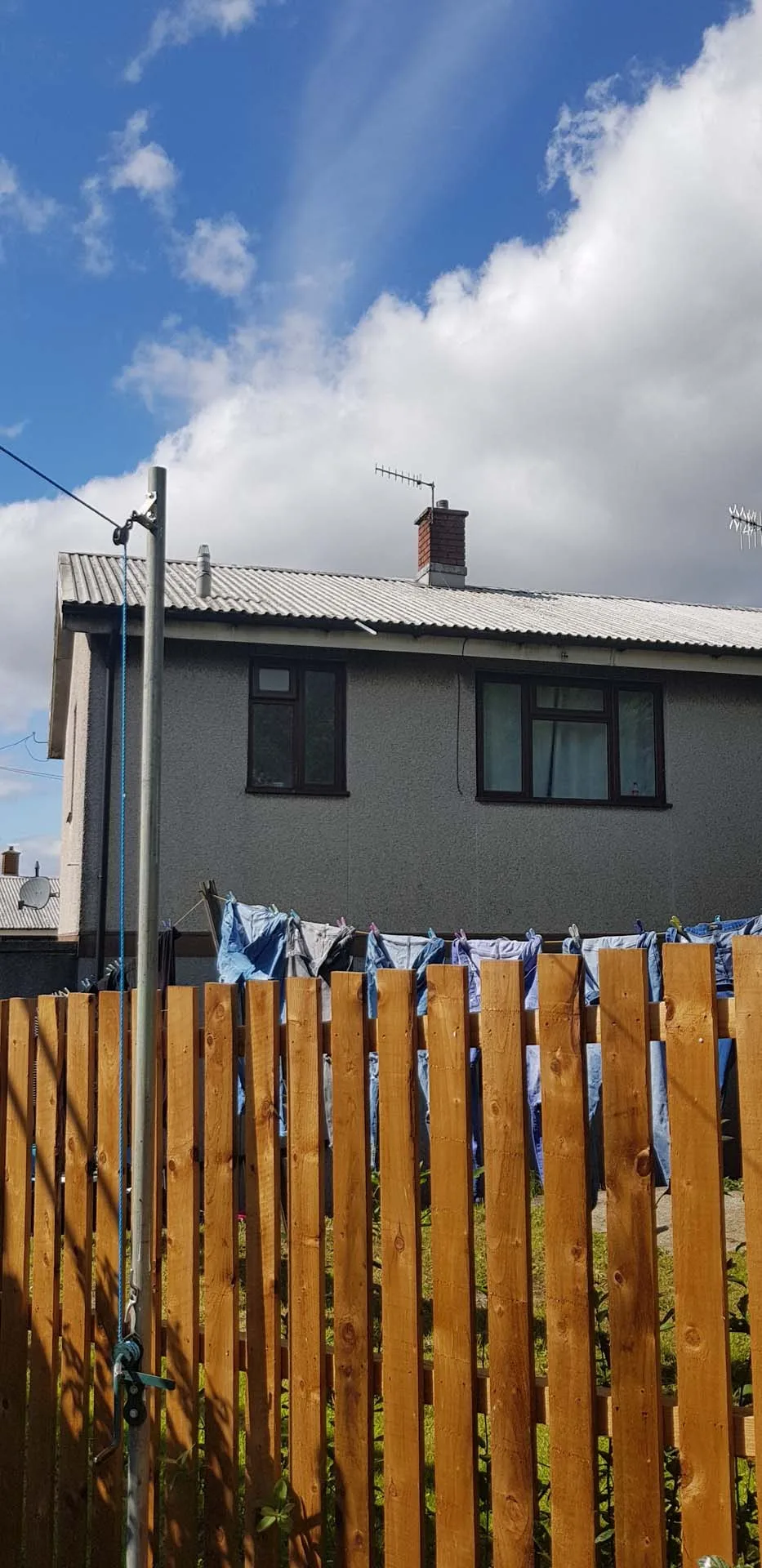 Post-war house with an old corrugated sheet roof before replacement