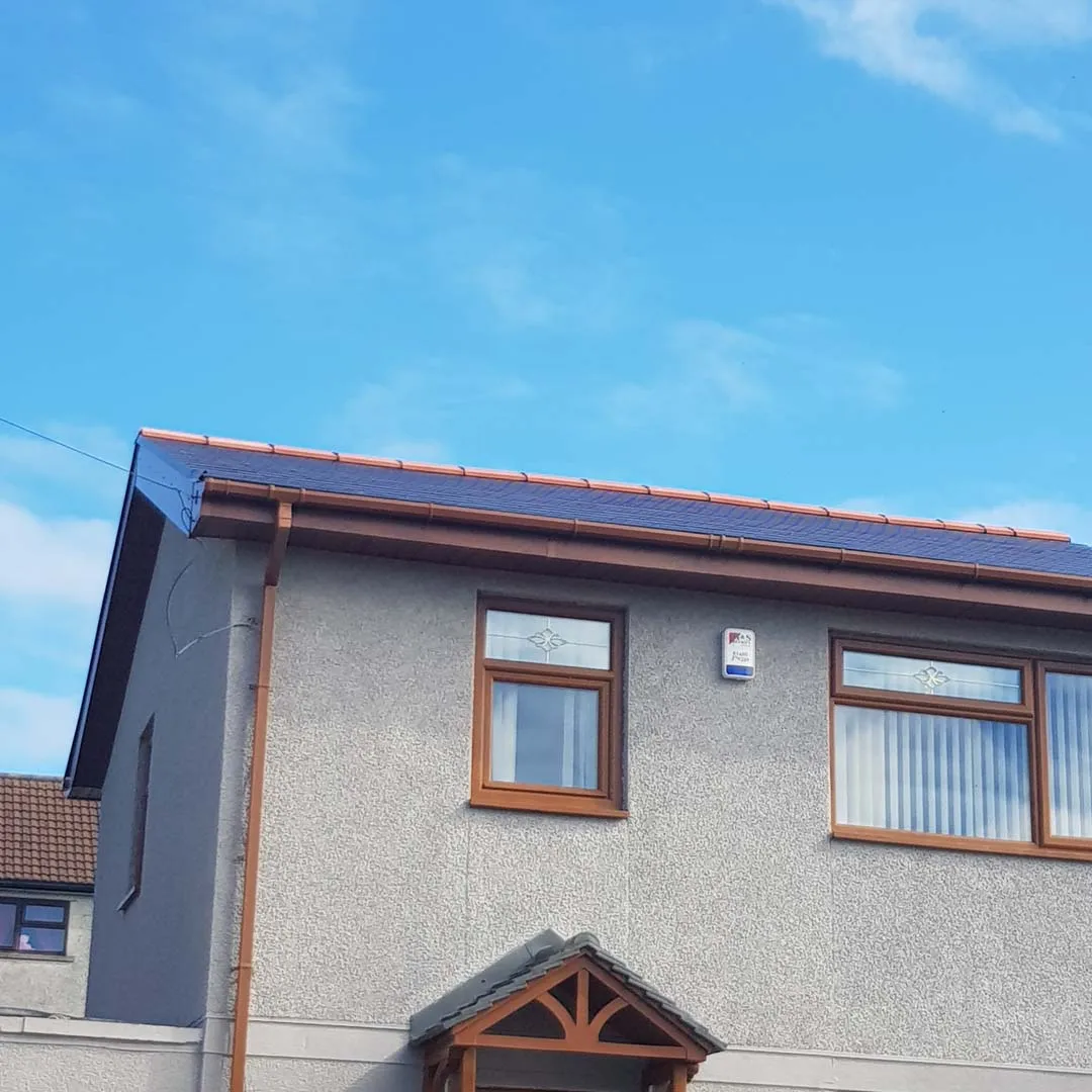 Tiled roof gable edge finished with a neat dark verge line and woodgrain roofline